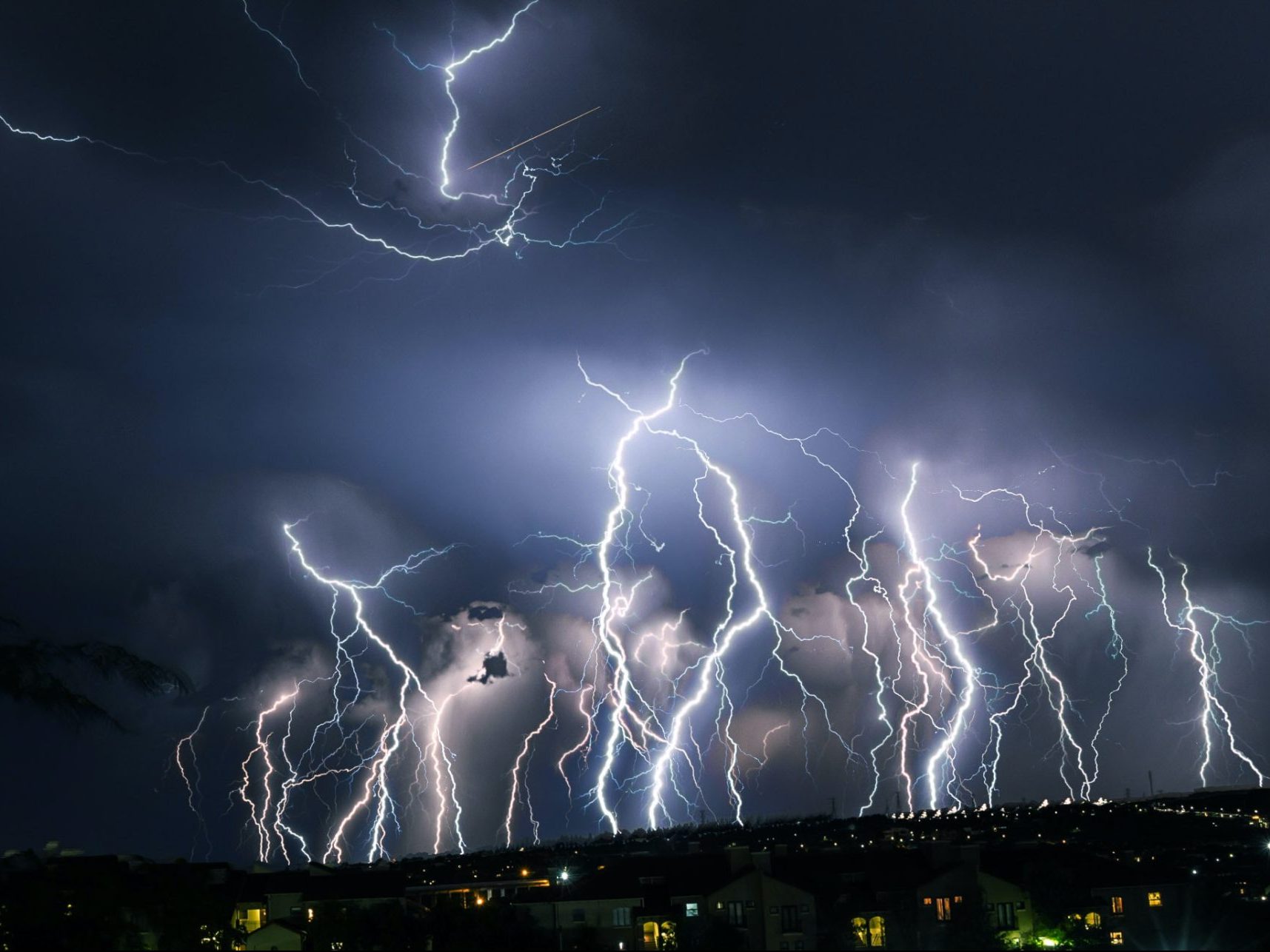 an article on natural disasters has a picture of lightning striking at night