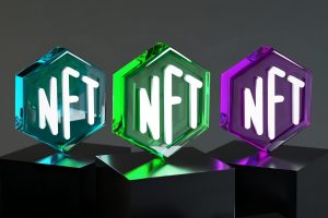 in an article about NFT games, three transparent blocks with the word NFT on them