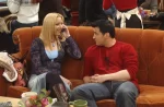"Friends" characters Joey and Phoebe sitting on a couch