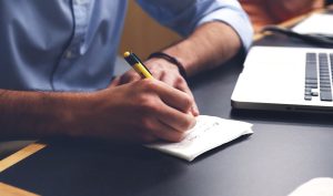 Photo of a man note-taking