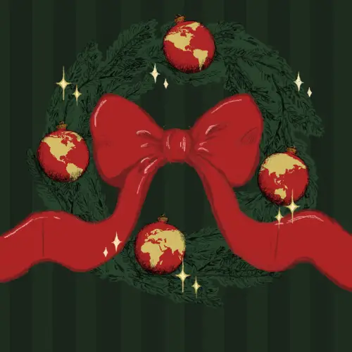 A green holiday wreath with a red ribbon and four red ornaments that look like the world.