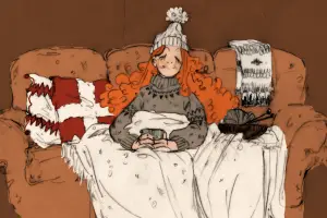 In an article about Hygge, a picture of someone on a couch wearing warm clothing and a blanket