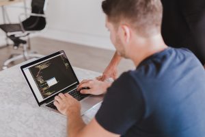 In an article about becoming a certified ethical hacker specialist, a man looks at a computer monitor.