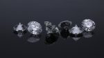 in an article about diamond alternatives, six diamonds lay in a row
