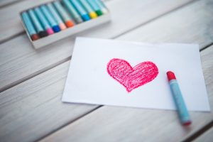 an oil pastel drawing of a red heart