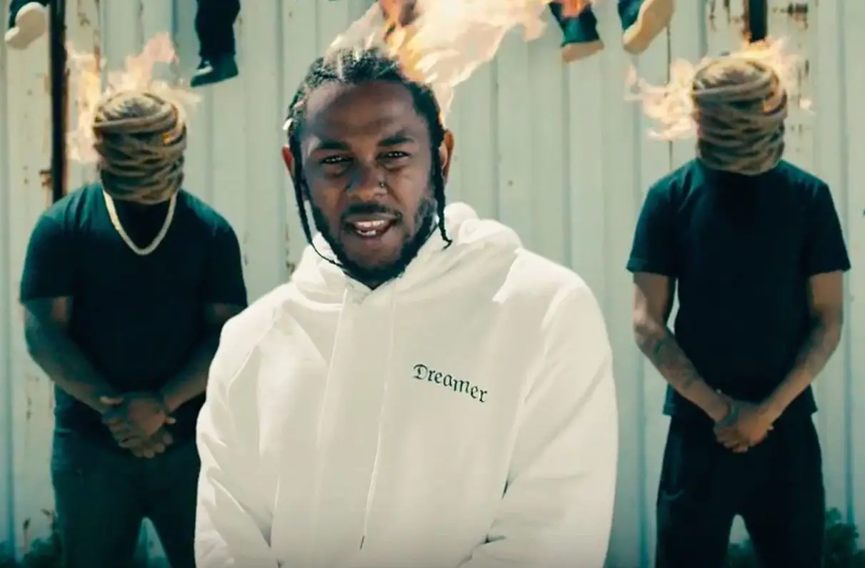 In an article about the Grammy nominees for best rap album, Kendrick Lamar appears in his 'Humble' video with his head on fire.