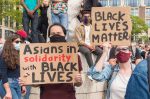 In an article about Asian Americans as a model minority, protesters gather at a BLM rally.