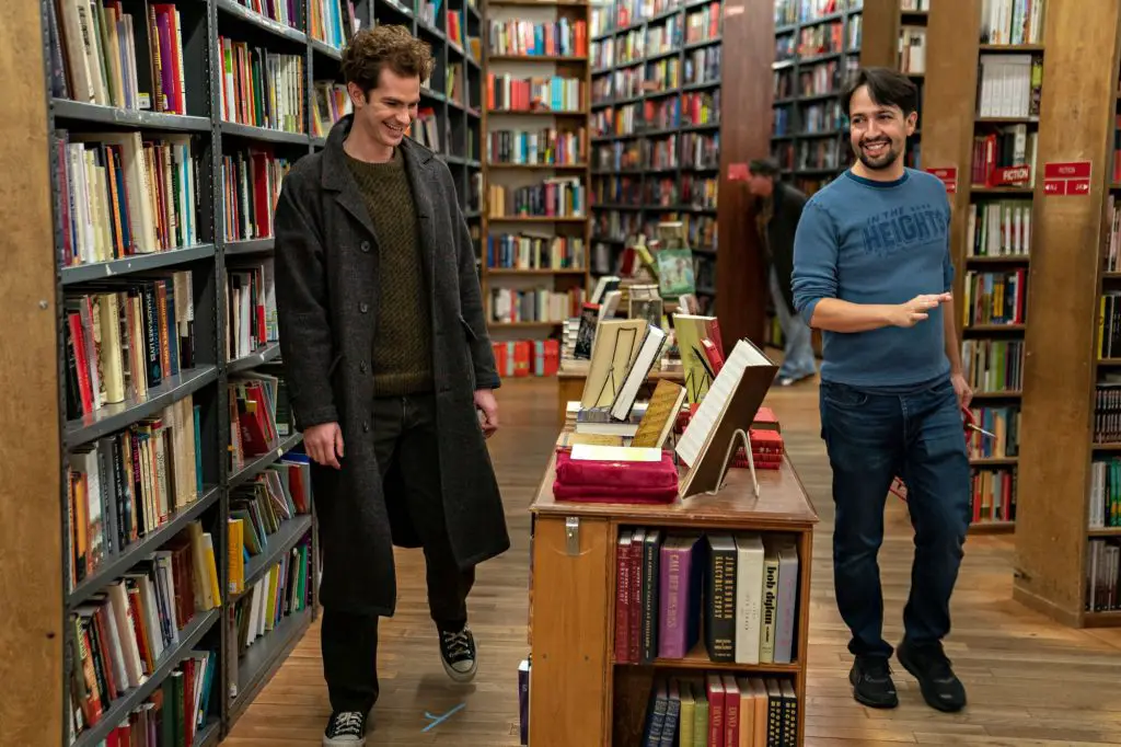 A screenshot from tick tick boom shows lin manuel miranda and another person in a bookstore