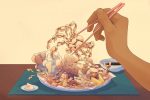 In an article about eating bugs, a person lifts up a fried spider with chopsticks.