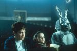 An image from Donnie Darko showing Donnie and Elizabeth Darko seated alongside Frank the Rabbit in a movie theater.
