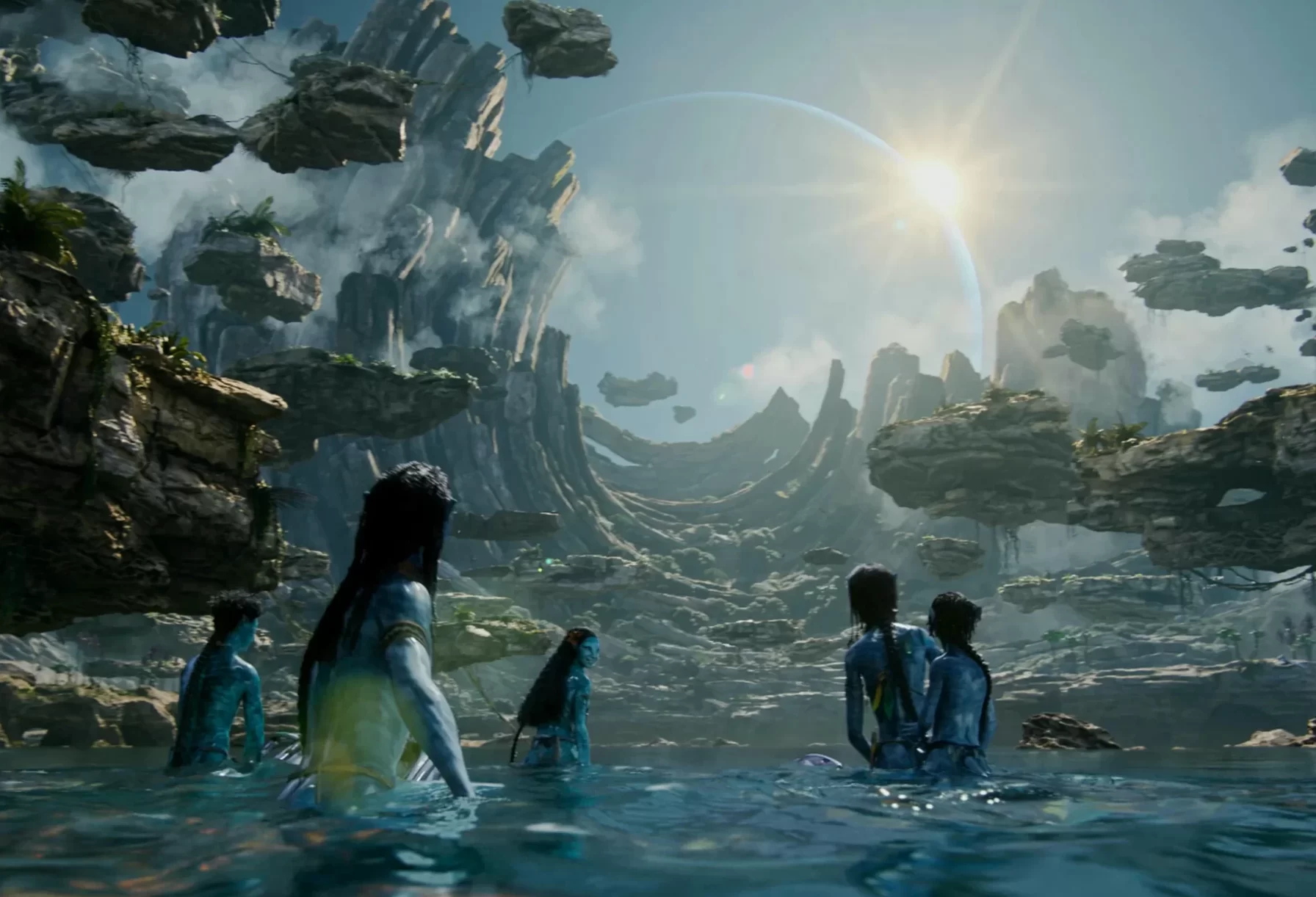 In an article about 'Avatar: The Way of Water,' the Navi people look up at the sun from the sea below.