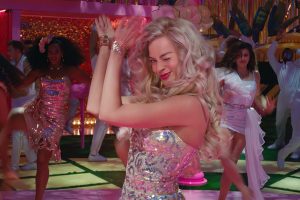 In the 'Barbie' movie trailer, Barbie claps and winks as her friends dance behind her.