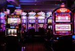 The interior of a casino, many slot machines in an article about casino bonuses.