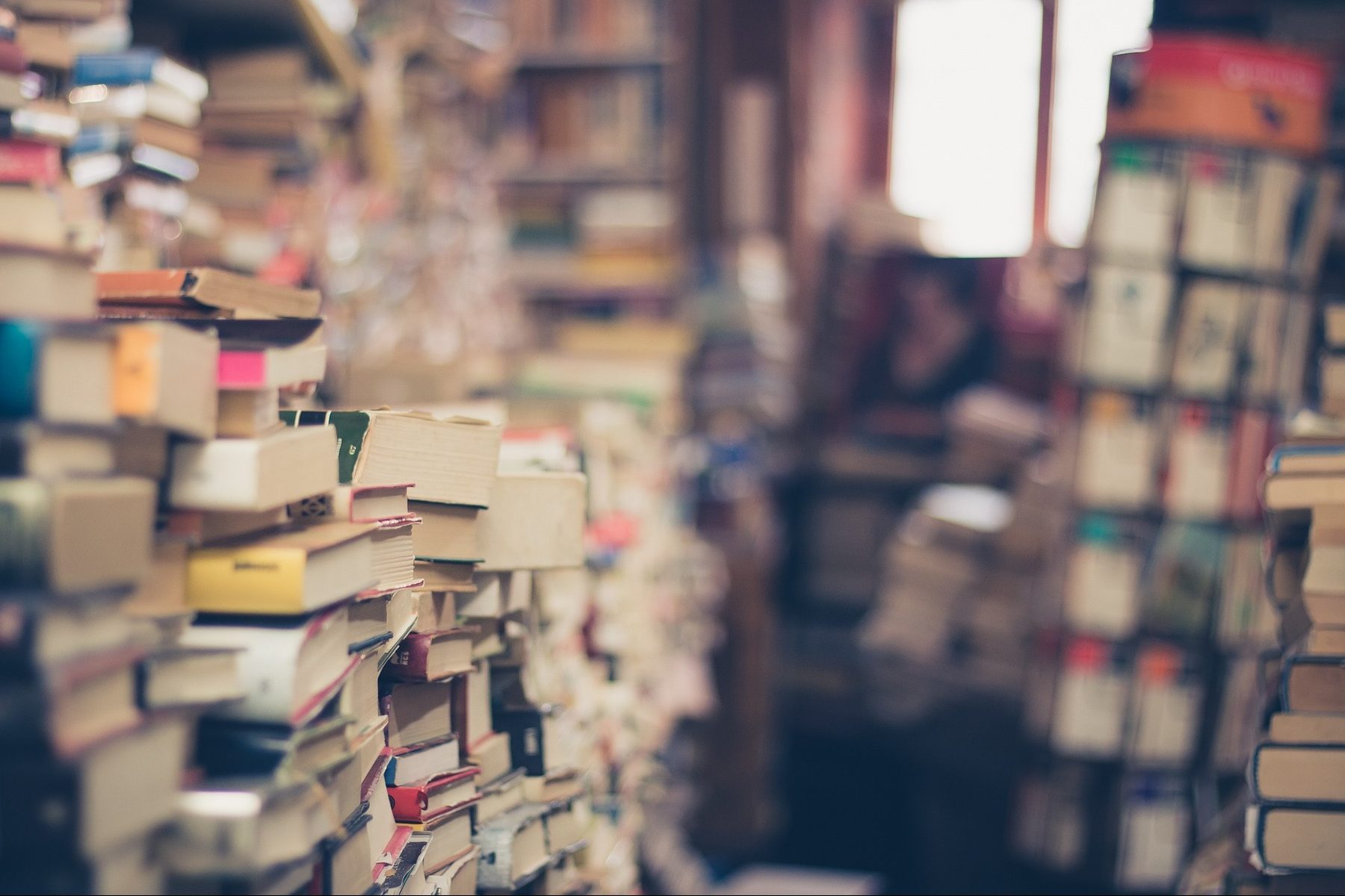 In an article about great books by Nigerian authors, the inside of a bookshop with piles of books all around.