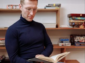 In an article about learning a new language, a man reads a book.