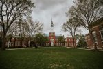 In an article about adapting to life as a college freshman, a majestic academic building with a clock tower in front of an expansive green.