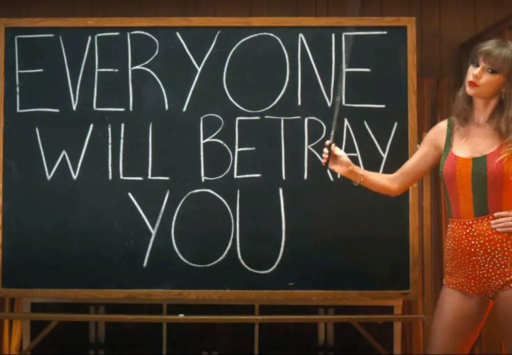 In an article about the Ticketmaster controversy over Taylor Swift tickets, an image of Taylor in front of a blackboard that says "everyone will betray you."