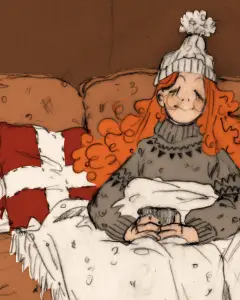 In an article about Hygge, a girl with long red hair sits on a couch with a mug of cocoa.
