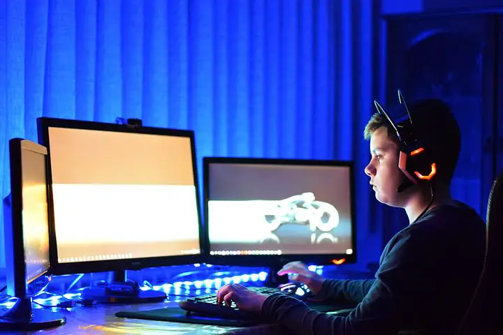 In an article about online game monetization, a child playing on a computer.