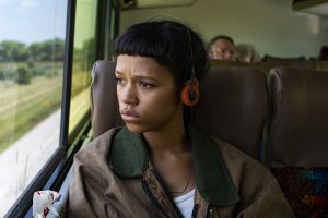 In an article about letterboxd, a young woman looks out the window of a bus.