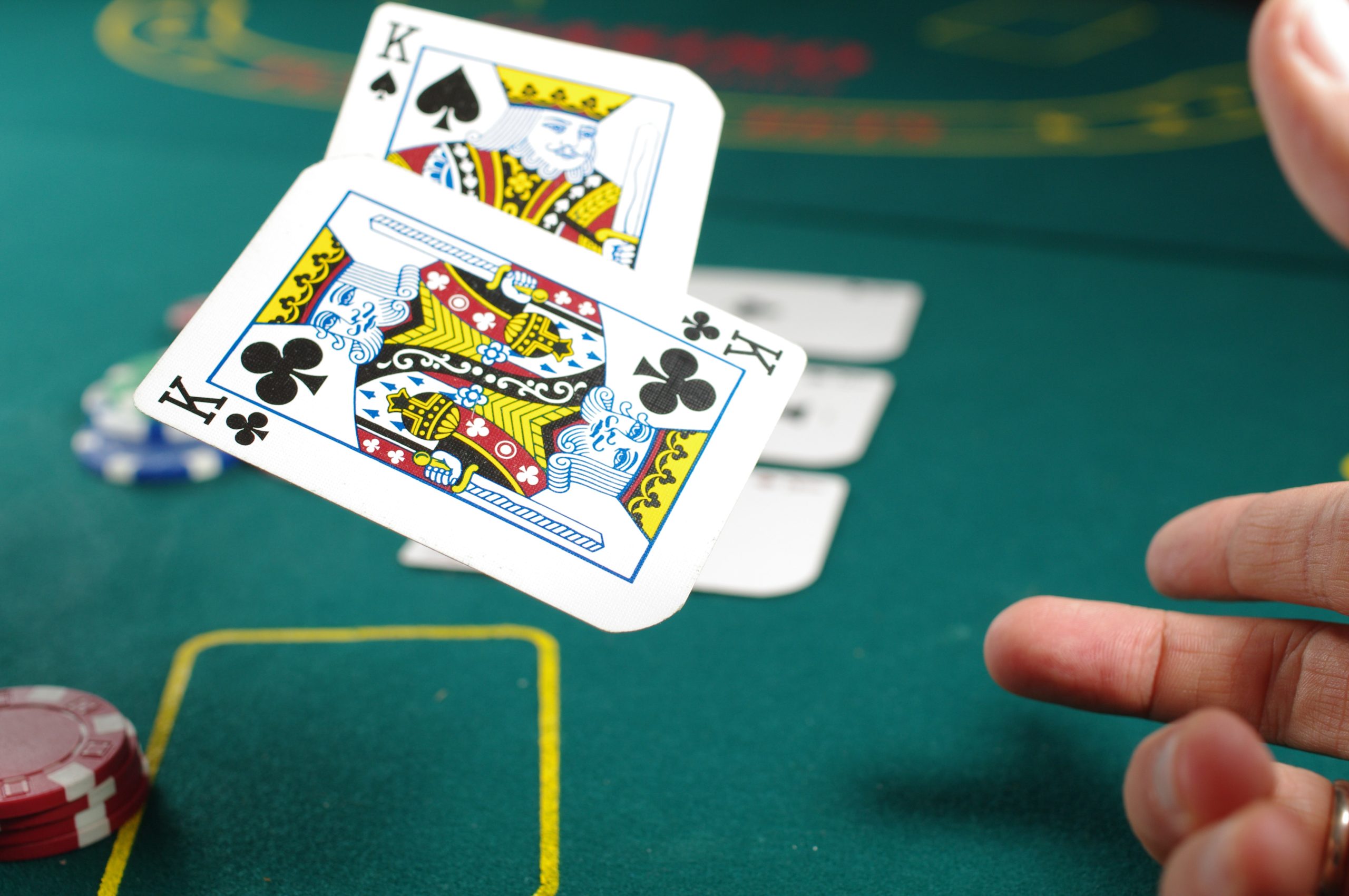 In an article about the best casinos in the world, a person flips two playing cards in the air.
