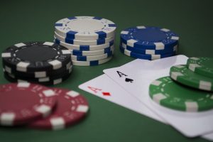 In an article about blackjack, several poker chips and cards lie on a table.