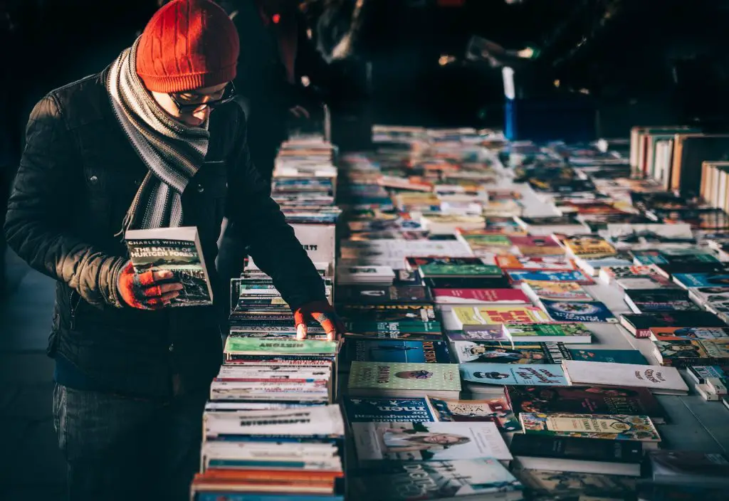In an article about Barnes and Noble, a book store customer browses through a table of various books,