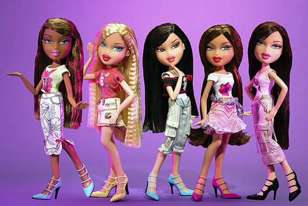 In an article about Bratz dolls, the girls show off their outfits in front of a purple background.