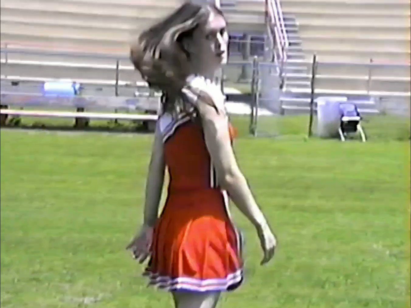 In an article about the singer-songwriter Ethel Cain, a frame from her music video "American Teenager" featuring the singer in a cheerleading outfit.
