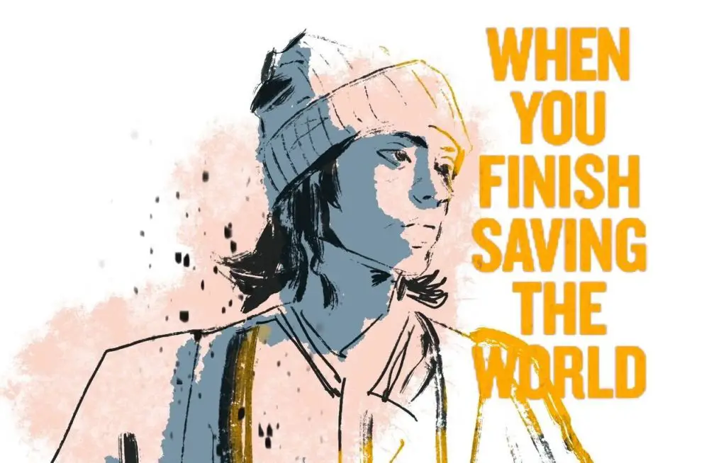 For an article about Jesse Eisenberg's directorial debut, a young man with chin-length dark hair, wearing a beanie, looks to the right where the words "When You Finish Saving the World" are written in yellow.