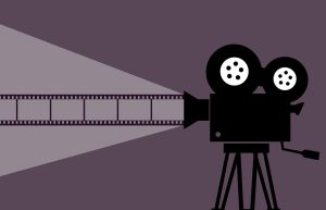 For an article about the Criterion Collection, a stylized black and white drawing of an old fashioned movie camera and film reel are placed over a purple background.