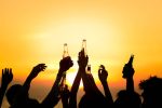 Friends Beach Party Drink beer, hold bottles up as a Toast Celebration