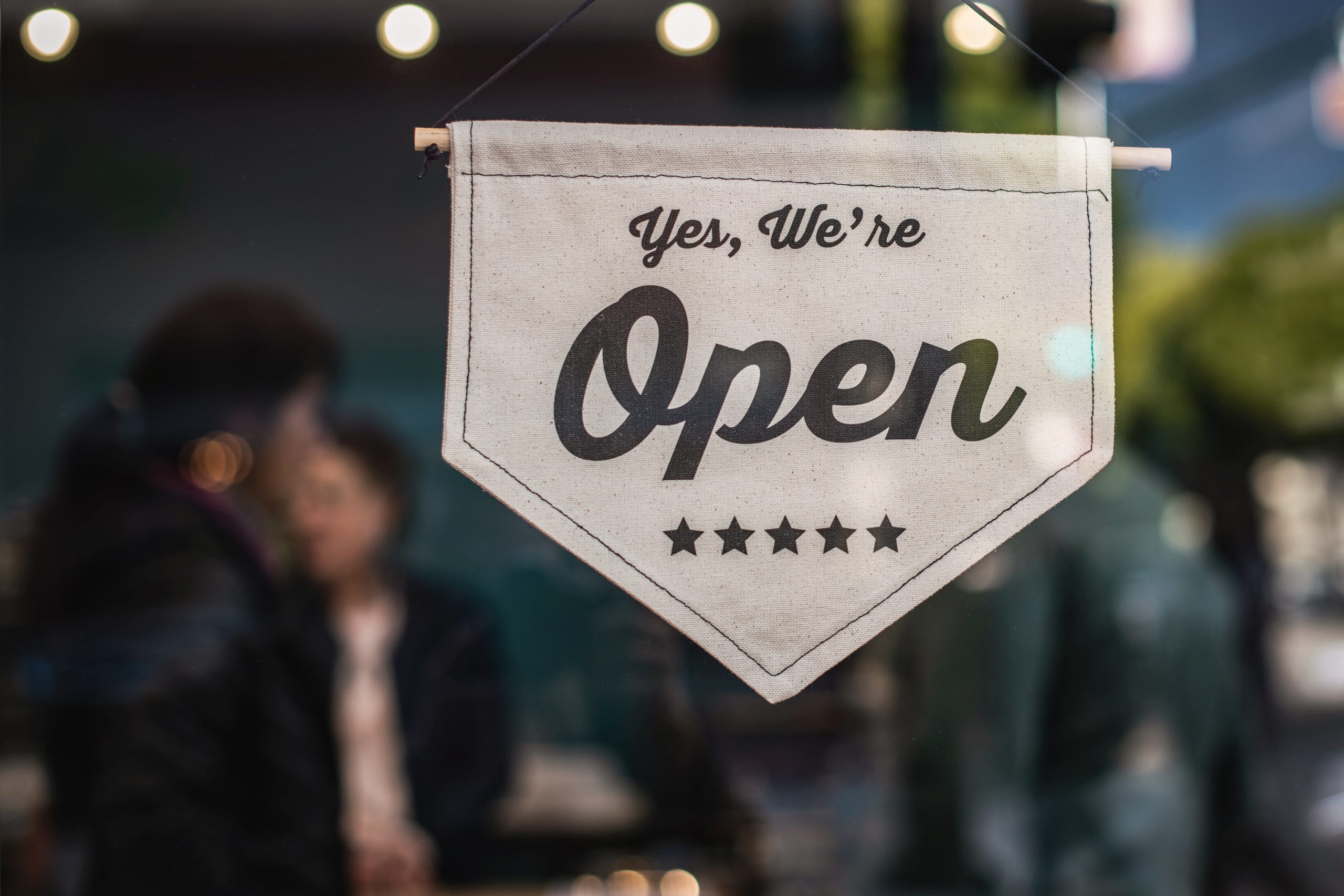 In an article about starting a small business, a cloth banner that reads "we're open."