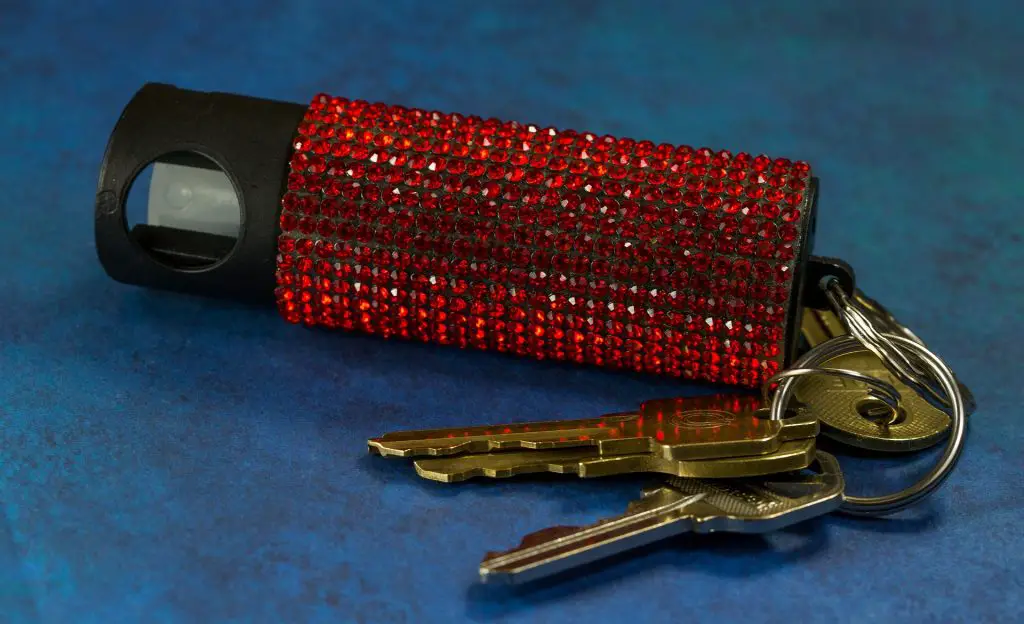 In an article about campus safety, a pepper spray cannister on a keychain features red sequins.