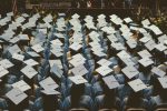 In an article about graduation, a sea of graduates at a commencement ceremony.