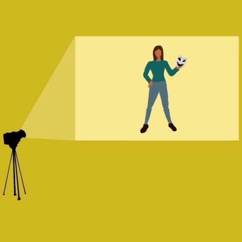 In an article about female-led comedies, a projector shines an image of an actress holding a comedic mask onto a yellow screen.