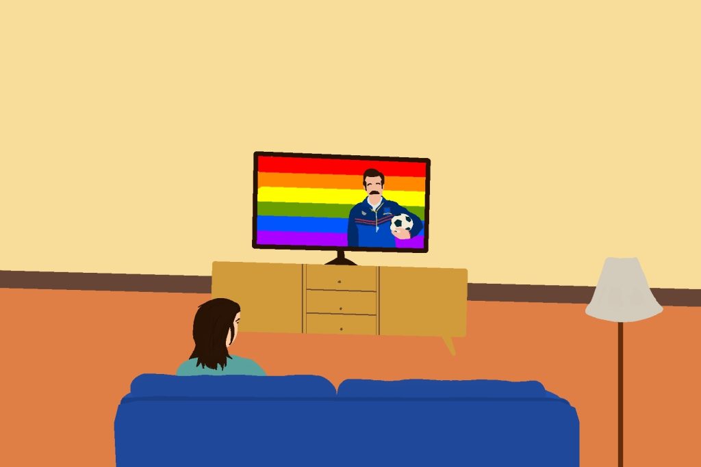 In an article about queer characters in 'Ted Lasso,' a figure watches the titular character in front of a rainbow background on the TV.