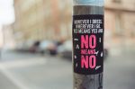 In an article about the Me Too movement a sticker on a sign post reads "However I dress, wherever I go, yes means yes and no means no."