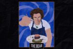 In an article about "The Bear," main character Carmy holds up a plate and fork to the viewer.