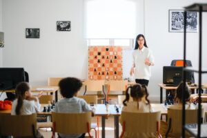 In an article about education woman standing in front of classroom.