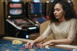 In an article about casino gaming a woman at a black jack table.