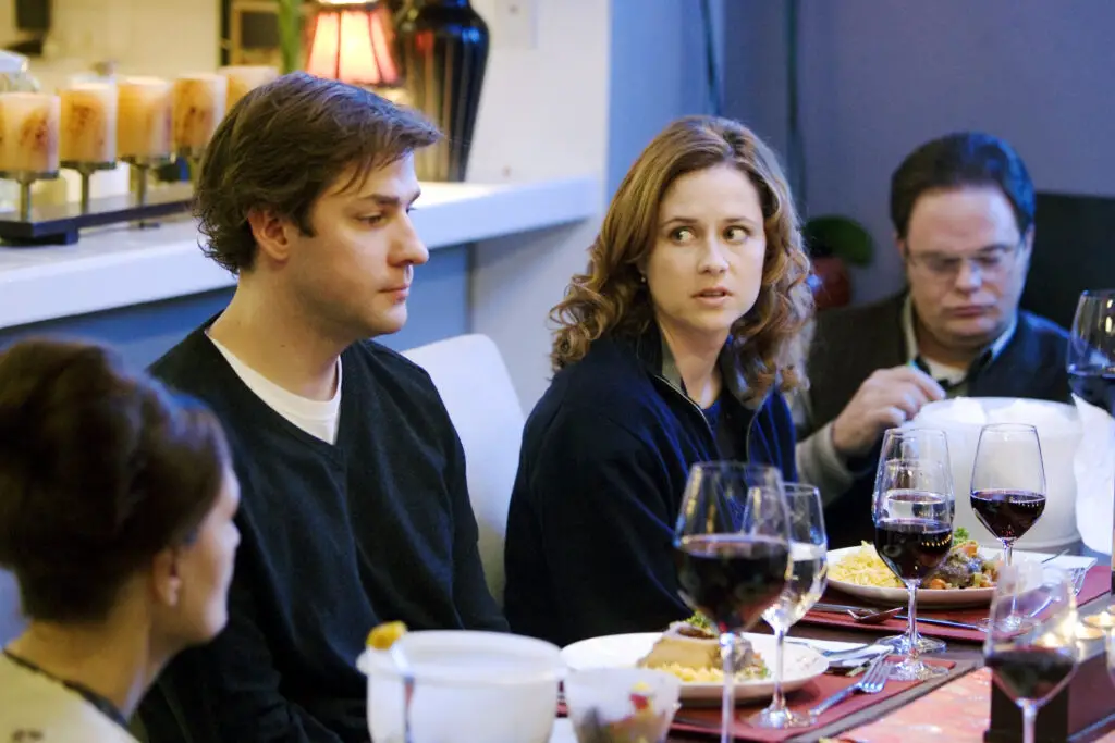 In an article about fantastic television episodes, Pam stares at Jim in utter disbelief and discomfort as Michael and Jan trade veiled insults across the dinner table.