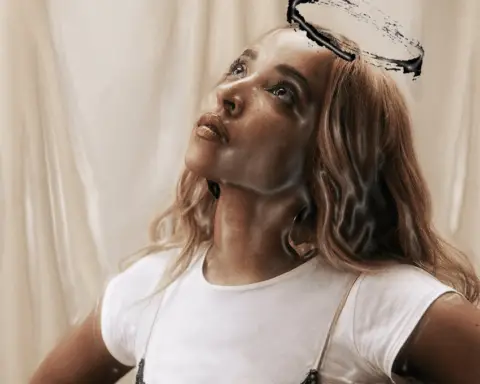 In an article about Tinashe's new album 'BB/Angel,' a woman with blonde hair looks up. She wears a white tee shirt with a slip dress over it. A hand-drawn angel halo is above her head.