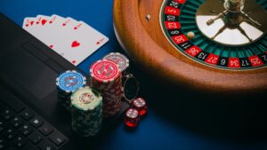 Roulette Wheel, cards and poker chips on a table