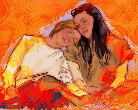 A blonde woman rests her head on a brunette, with a swirling orange and red background.