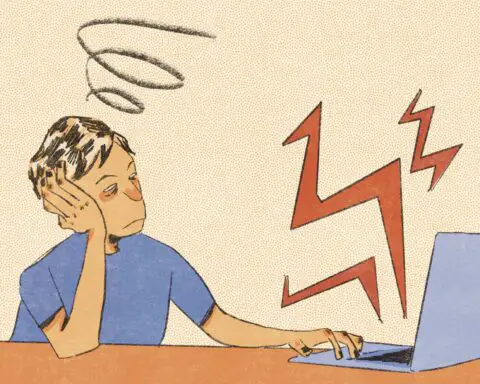 for an article on silent quitting, a person with short hair and a blue shirt stares drearily at a computer screen.