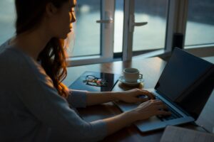 Woman writing on laptop