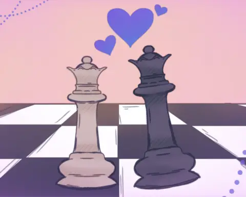 Against a pink background, a tan queen and a black king chess piece leans towards one another on a chess board with purple hearts in between them.