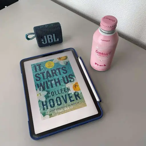 Photo of a book and water bottle on a table