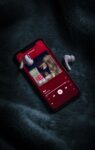 Phone with Taylor Swift Red and earbuds